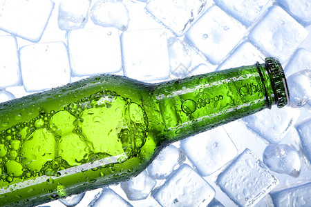 冰冻中的冷啤酒茶点瓶子液体立方体玻璃派对冰块气泡金子冷藏背景图片