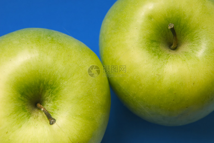 蓝色背景上两个开胃苹果色绿色的蓝底苹果水果保健早餐饮食甜点宏观节食卫生诱惑小吃图片
