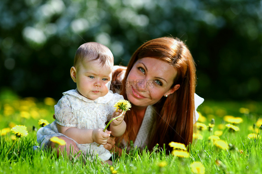 母亲和女儿在绿草上青年妈妈女士女孩男生女性孩子公园童年快乐图片