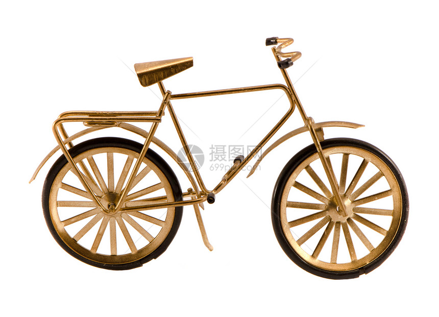 白色上孤立的小型金色玩具小金色自行车图片