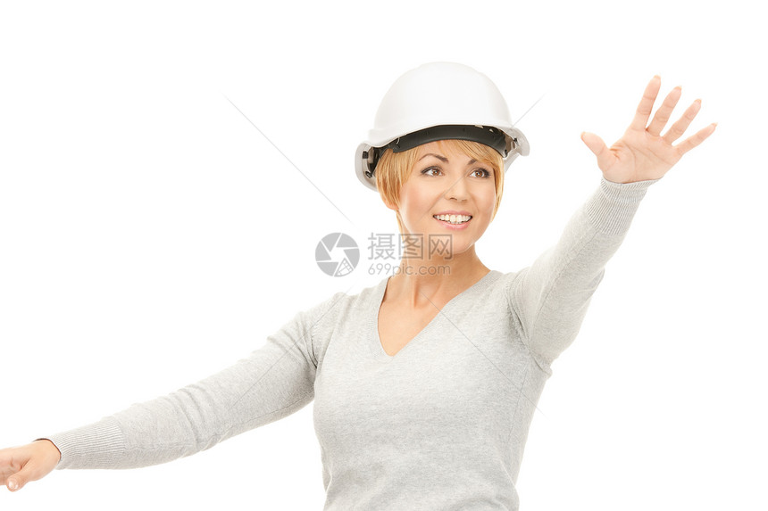 戴头盔的女女承包商与想象中的东西一起工作手势商业手掌开发商建筑微笑建筑师工程师商务女士图片