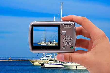 照相机和游艇拇指汽艇相机拍照爱好血管天空展示帆船港口背景图片