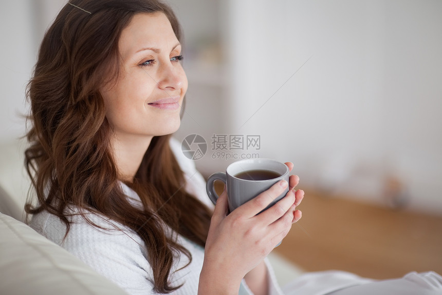 女人笑着看远陶器高脚杯沙发微笑棕色陨石咖啡休息室饮料女性图片