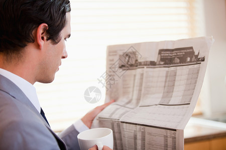 商务人士阅读报纸的侧面观点背景图片