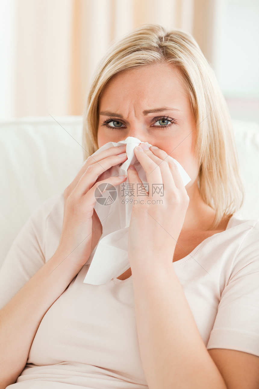 一个疲累的女人吹鼻涕的肖像图片