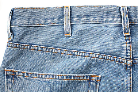 破旧牛仔裤褪色牛仔布衣服口袋蓝色背景图片