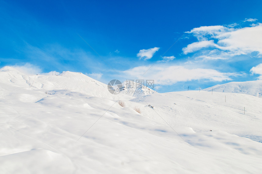 明亮的冬天天雪山山脉场景假期蓝色全景冰川白色太阳岩石滑雪图片