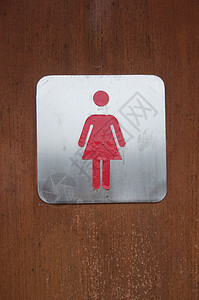 在厕所前面的女符号背景图片