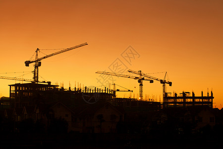 建筑工地脚手架住宅建筑工人项目活动日落起重机工程结构框架背景图片