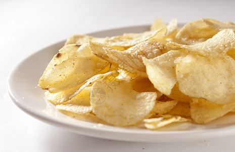 土豆薯片白色油炸香料筹码食物盘子黄色小吃背景图片