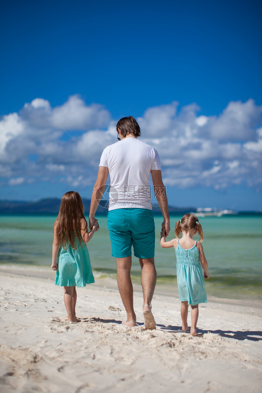 父亲和他的两个孩子在海边散步假期白色爸爸家庭成人女孩异国热带父母情调图片