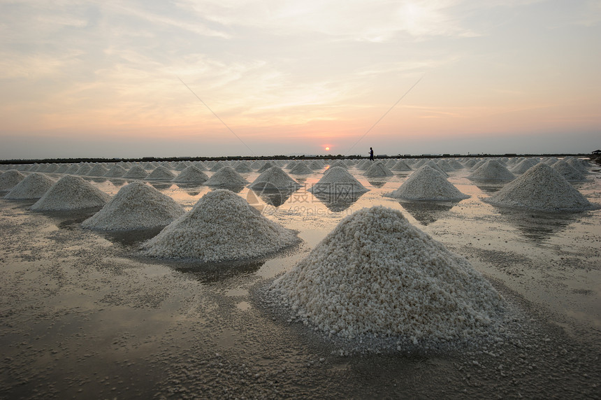 泰国海岸农村地区盐池里的盐堆里有盐蓝色订金池塘长方形天空勘探农民培育盐渍矿物图片