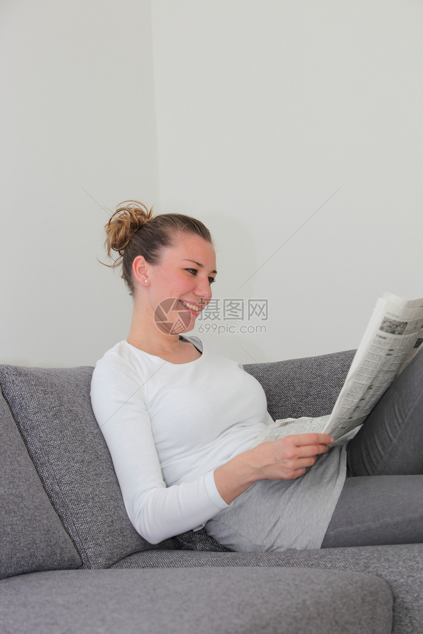 妇女享受她的晨报杂志图片