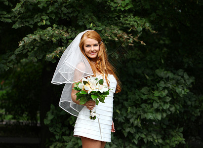 穿着婚纱的美丽红发新娘礼服派对婚礼女性裙子幸福花束公园花朵青年婚姻高清图片素材