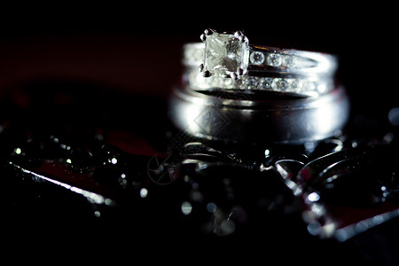 黑纹背景的钻石婚戒组织环浪漫珠宝仪式订婚已婚套装镶嵌婚姻黑色金属背景图片