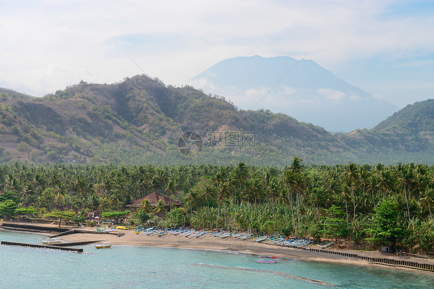 具有火山背景的热带热带海滩旅游风险支撑异国阳光棕榈情调天空蓝色码头图片