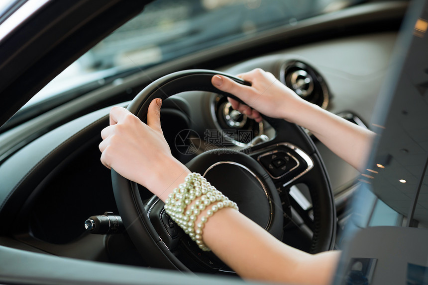 女人的手握在新车轮上女性活动运输里程表旅行速度杠杆镜子女士手臂图片