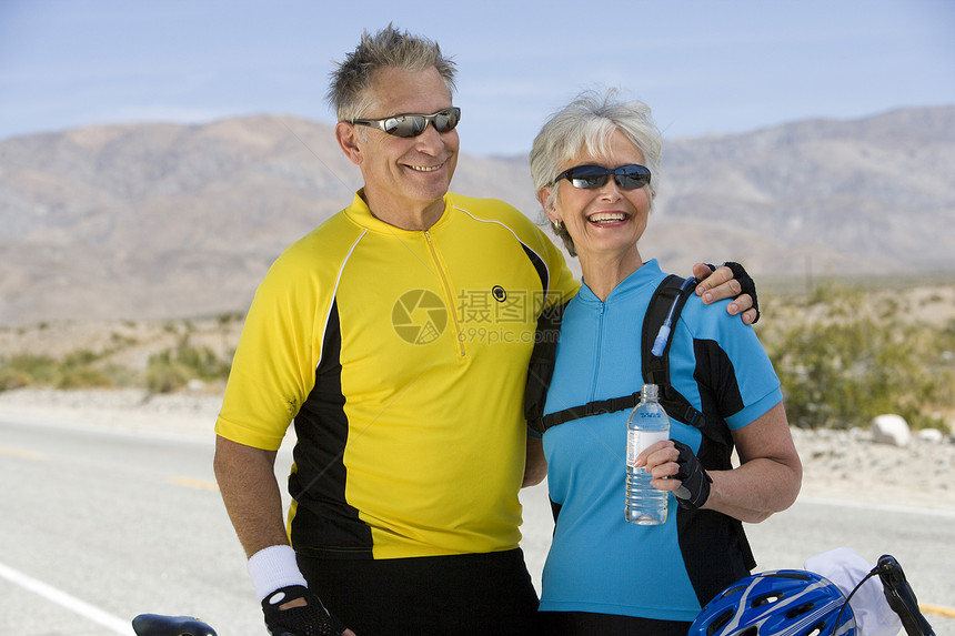 穿着运动服的快乐老年情侣 在背景中与山脉相望而去图片