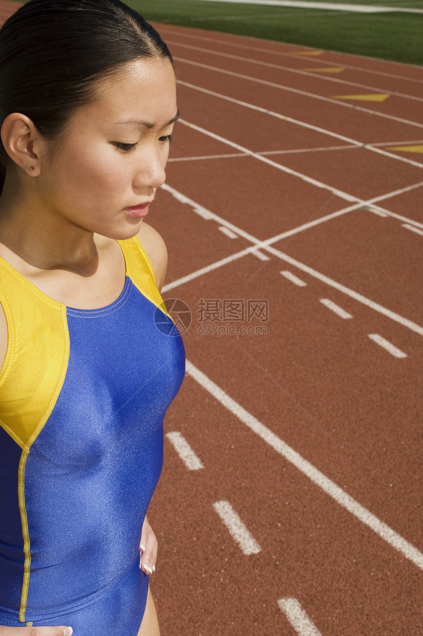 亚裔女运动员在赛道上穿运动服图片