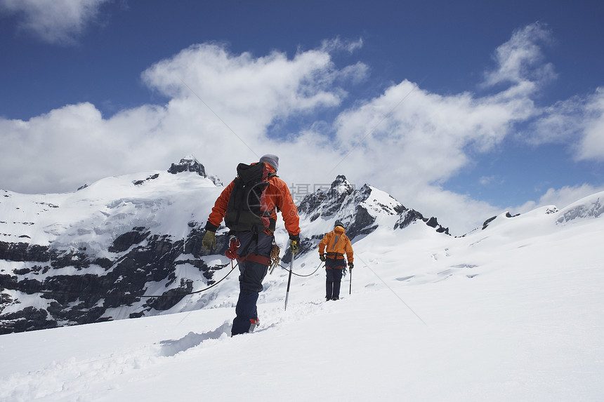 雪山安全线连接的两座徒步者近视图片