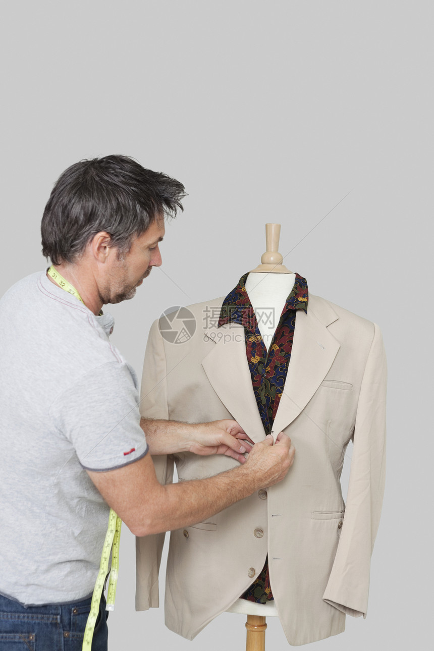 男装裁缝调整西装 在裁缝的假冒色背景上图片