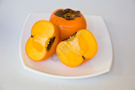 Persimmon 双环西蒙橙子饮食食物柿子市场维生素白色水果热带营养背景图片