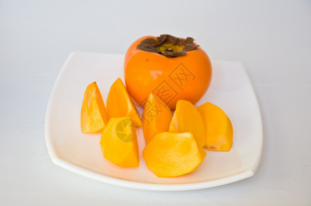 Persimmon 双环西蒙饮食食物橙子营养市场柿子热带白色水果维生素背景图片
