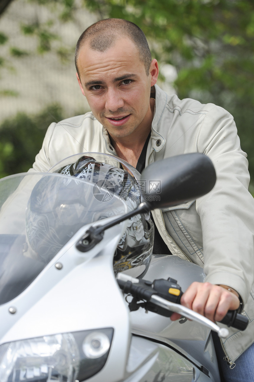 骑摩托车的年轻人外貌乐趣太阳活动头盔风险把手司机机器驾驶图片