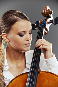 美丽的大提琴家独奏者音乐乐器古典音乐交响乐女子音乐家女性大提琴手女孩背景图片