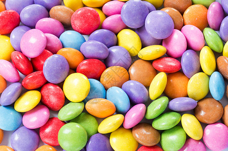 果冻按钮多彩多彩的巧克力糖果绿色聪明人小吃黄色蓝色味道圆形红色甜点食物背景
