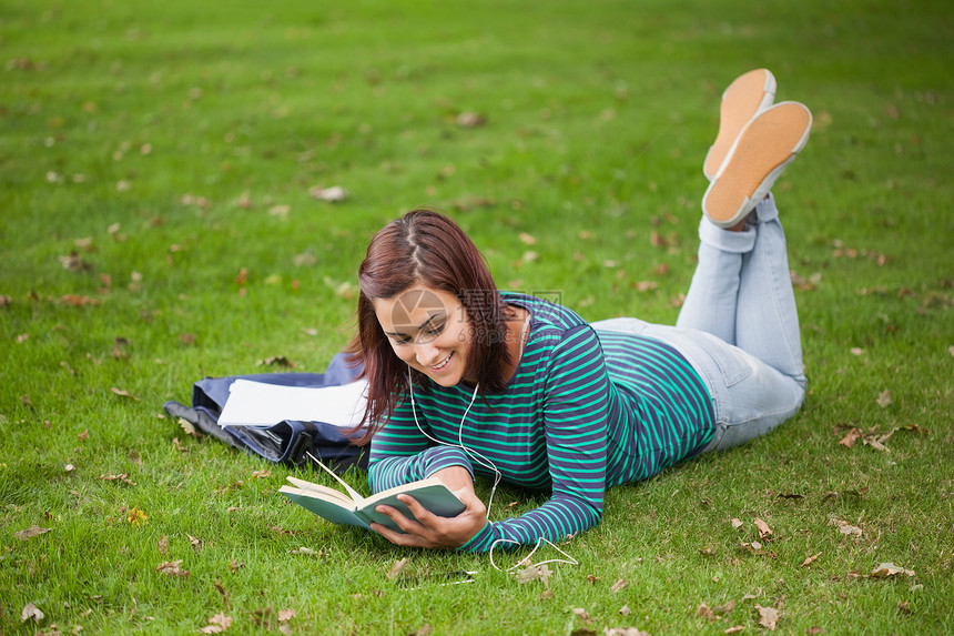 躺在草地上读书的快乐学生图片