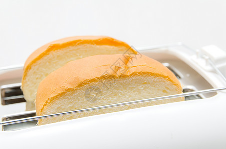 面包和托阿斯特小麦厨具早餐烹饪厨房燃烧食物机器脆皮小吃背景图片