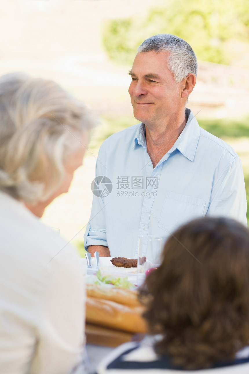 在户外餐桌有家人的老年人图片