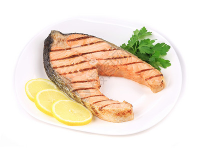 填料白色含蔬菜的灰色鲑鱼填料器条纹白色餐厅柠檬圆形油炸黄色正方形盘子鱼片背景