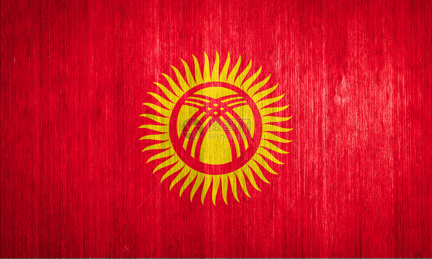 吉尔吉斯斯坦在木材背景上的旗帜图片