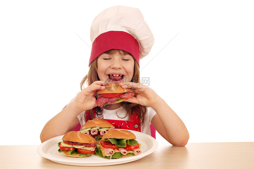 饥饿的小女孩烹饪吃三明治图片