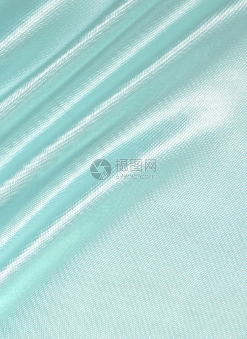 平滑优雅的蓝色丝绸作为背景曲线材料投标海浪折痕纺织品织物银色布料图片