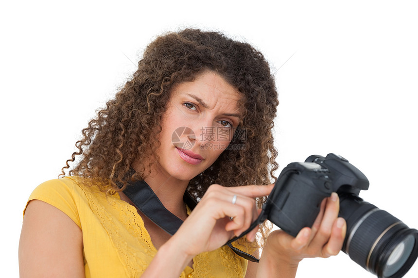 一名女摄影师的肖像摄影相机闲暇技术女士卷发单反女性爱好头发图片