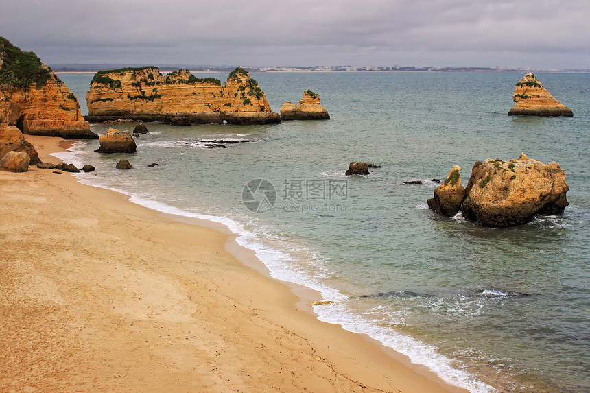 葡萄牙拉各斯岩石海滩海洋侵蚀日落赭石天空旅行晴天海角图片