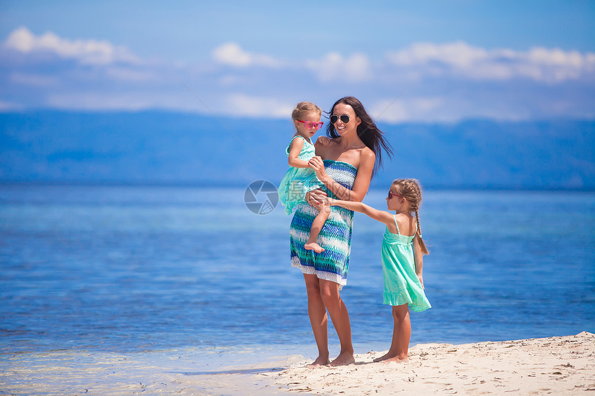 荒岛热带白色沙滩上的可爱小女孩和年轻母亲父母女性妈妈海岸假期享受情调女孩家庭女儿图片