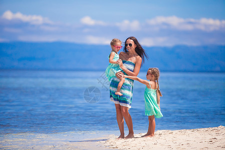 荒岛热带白色沙滩上的可爱小女孩和年轻母亲父母女性妈妈海岸假期享受情调女孩家庭女儿成人高清图片素材