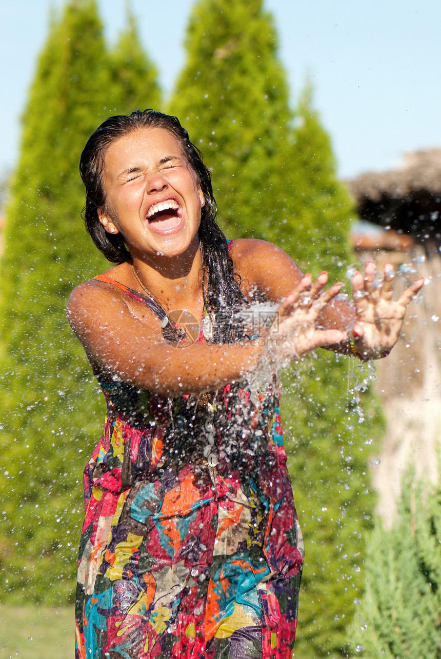 喝淋浴水的年轻女孩青年假期女士笑声水域持有情绪公园晴天图片
