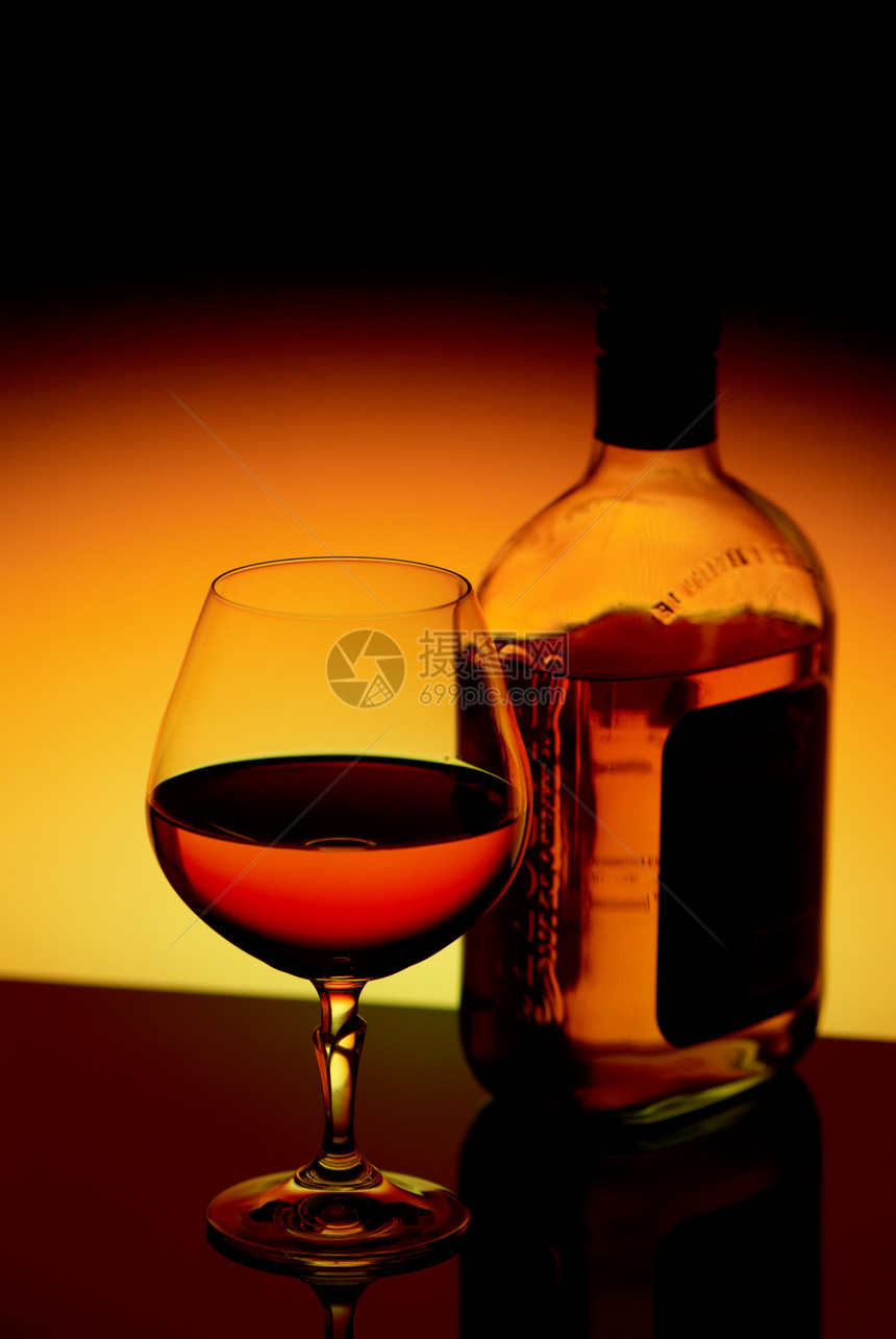 在明亮的背景中饮烈酒酒精玻璃工作室液体瓶子球杯橙子黄色红色黑色图片