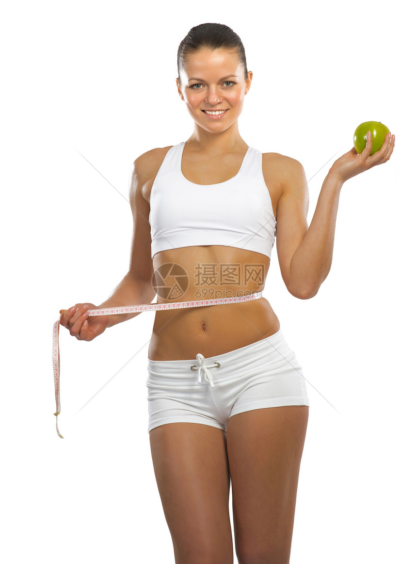 拥有绿苹果的年轻运动妇女重量橘皮减肥身体女士健身房水果女孩营养饮食图片