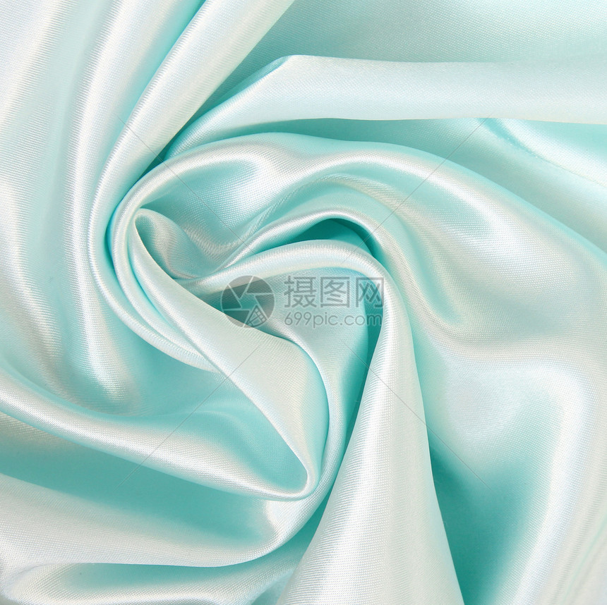 平滑优雅的蓝色丝绸作为背景折痕曲线投标纺织品织物银色海浪布料材料图片