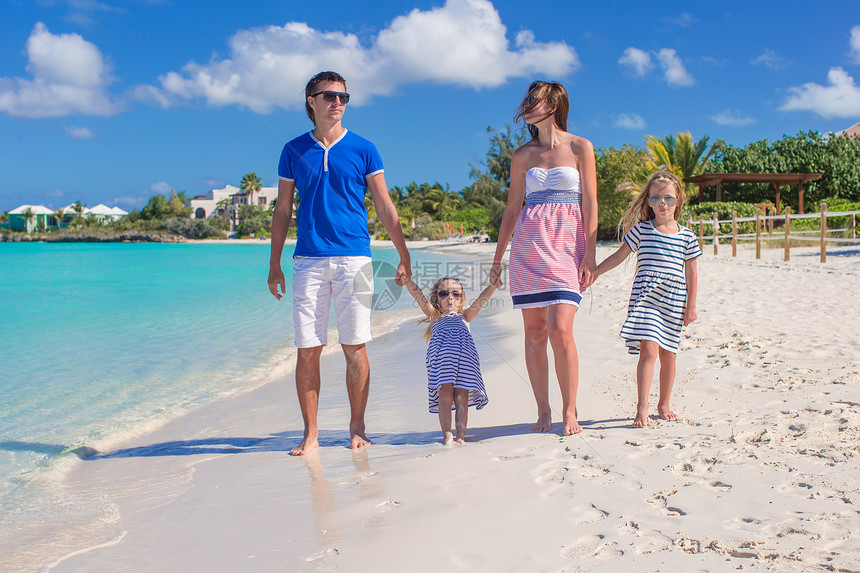 和两个孩子一起过暑假的幸福家庭父母女性婴儿海洋旅行假期海岸线女儿海滩海岸图片