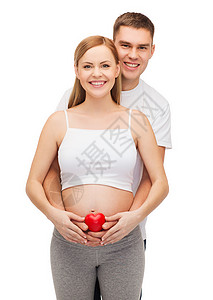 幸福的年轻家庭以心怀子女丈夫男生父亲生活母亲怀孕腹部女孩婴儿父母情人节高清图片素材
