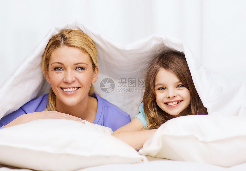家中被毛毯盖着的母亲和小女孩母性女性房间孩子幸福房子卧室喜悦女儿微笑图片