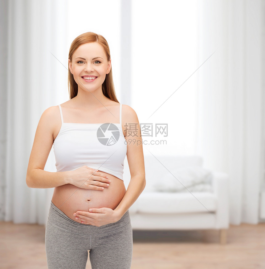 未来幸福的母亲抚摸她的肚子腹部房间母性父母微笑男生怀孕身体女士女孩图片