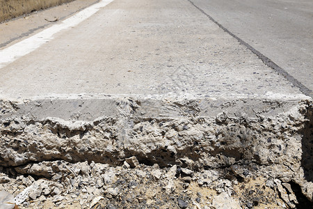 分层切割道路水泥挖掘机土壤碎石建造岩石工作地面维修裂缝背景图片